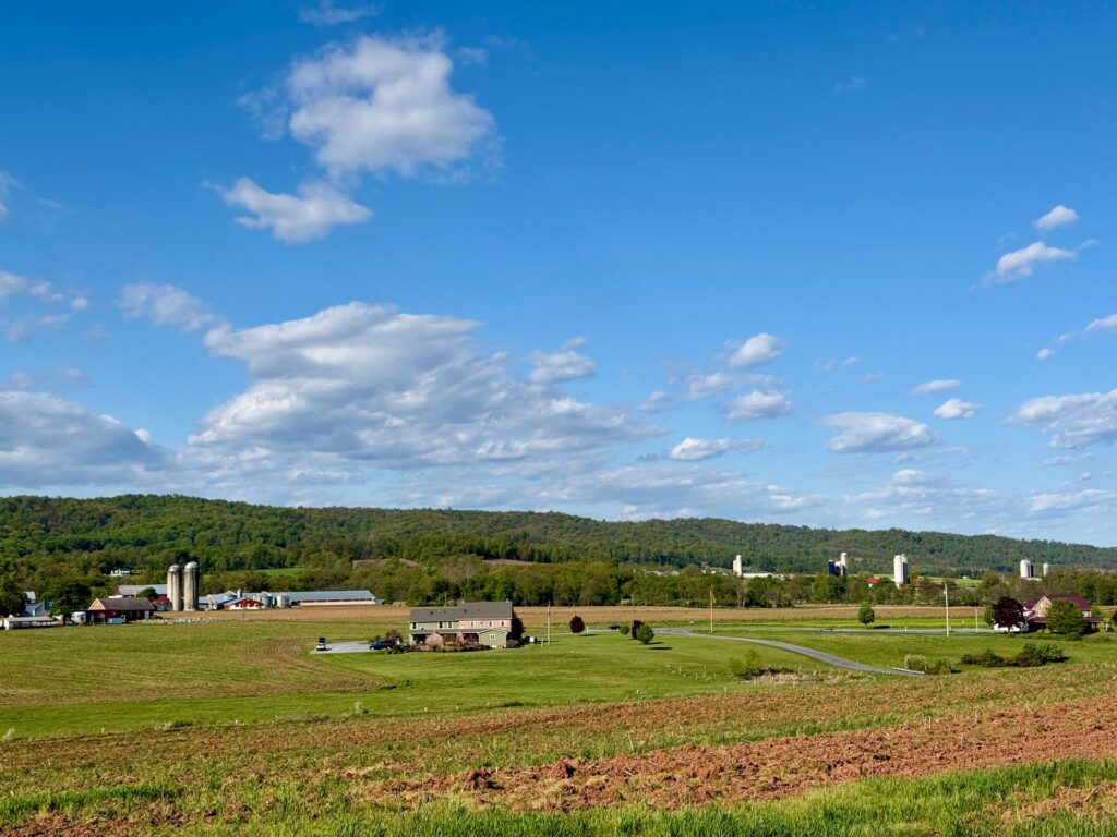 Rolling Pennsylvania farmland under a blue sky