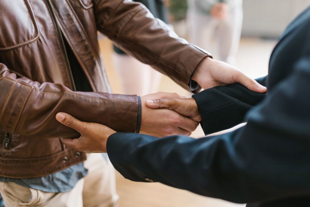 Business owner shaking hands with a payments partner